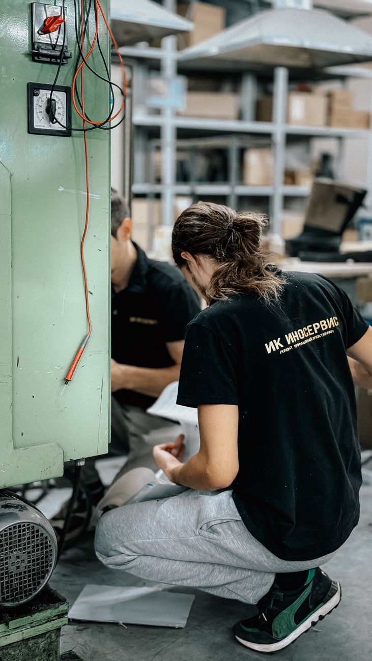 technician repairing machinery in workshop